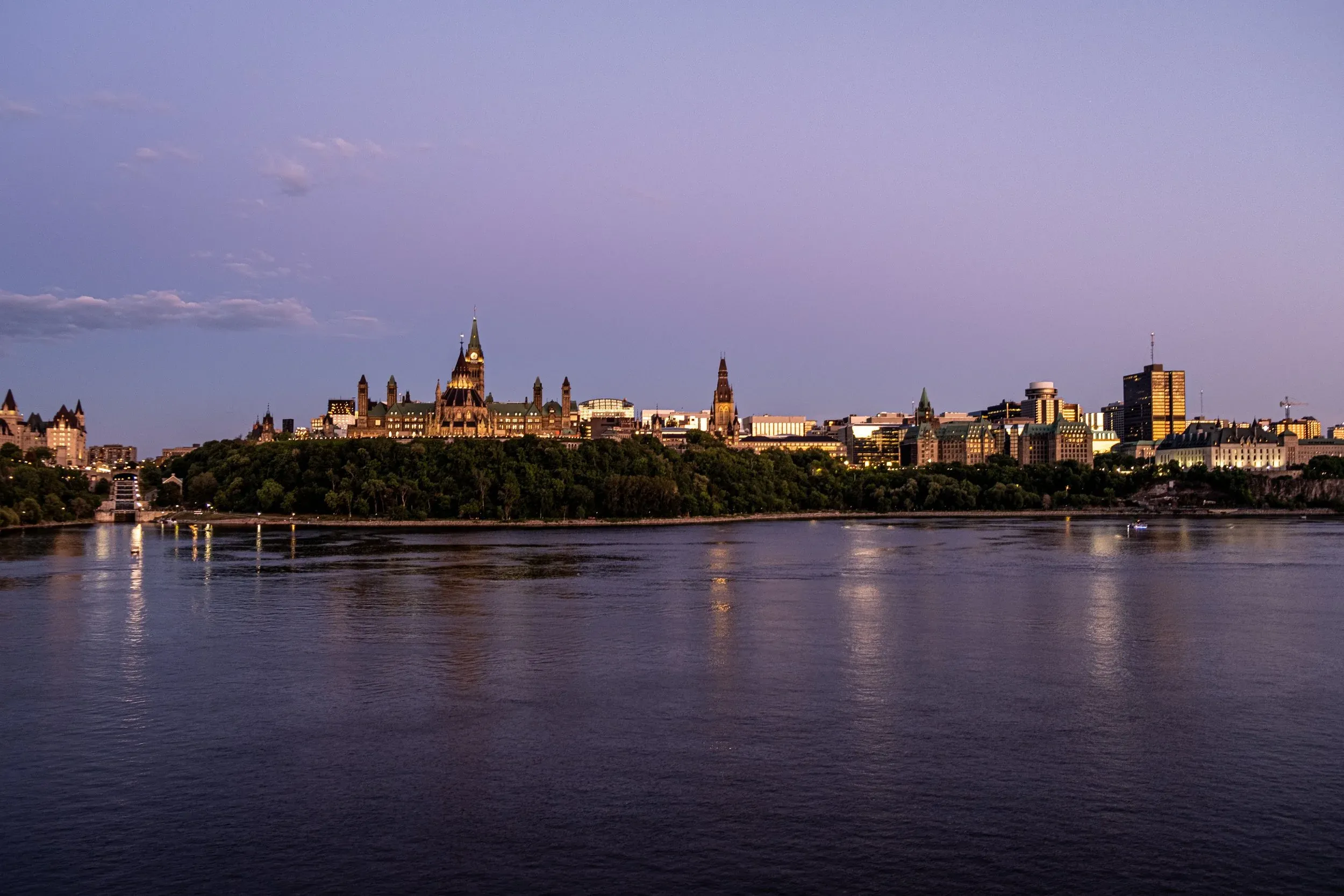 Parliament Hill and the Ottawa River at dusk