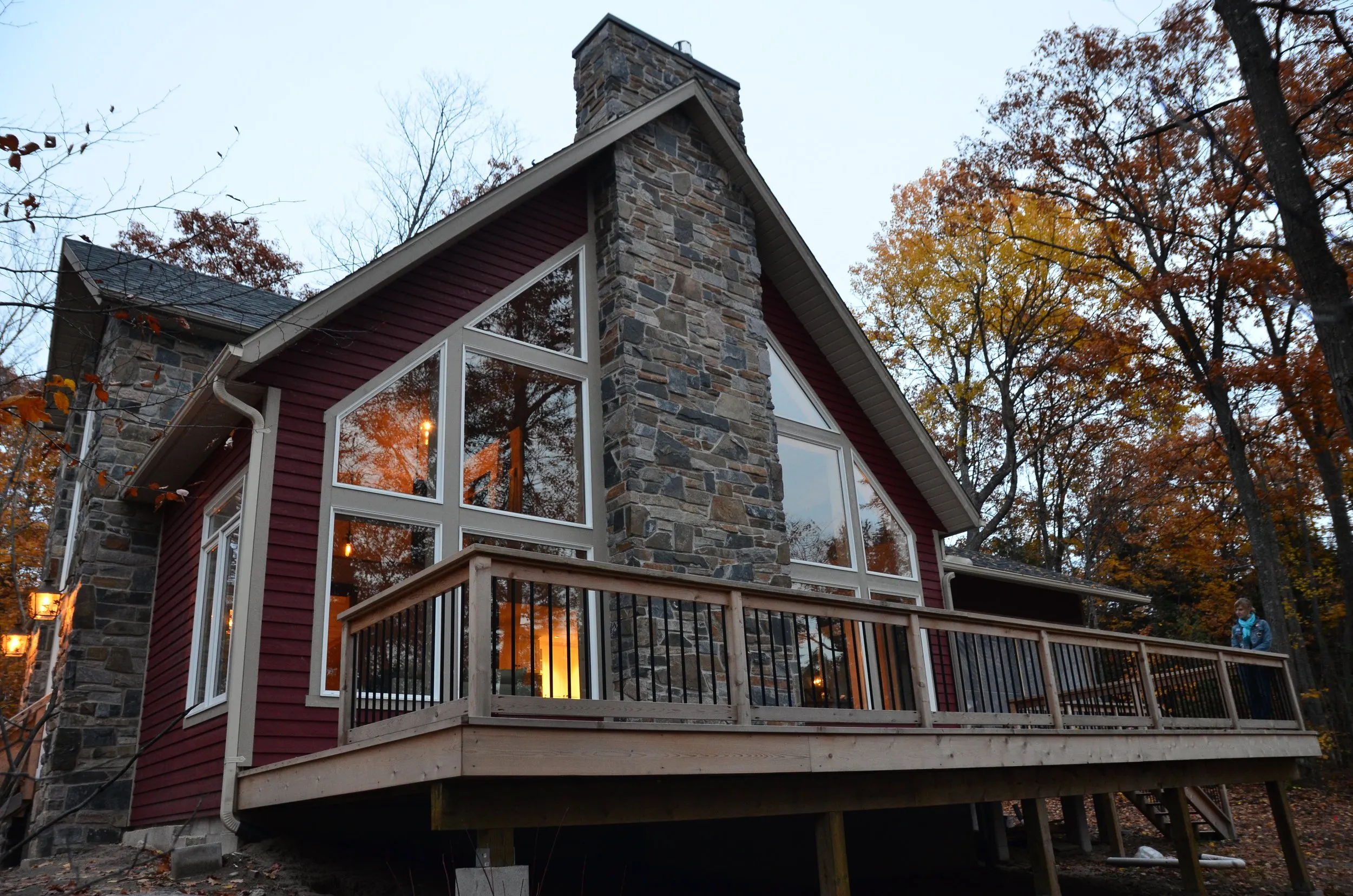Stone and timber Centennial cottage surrounded by autumn forest